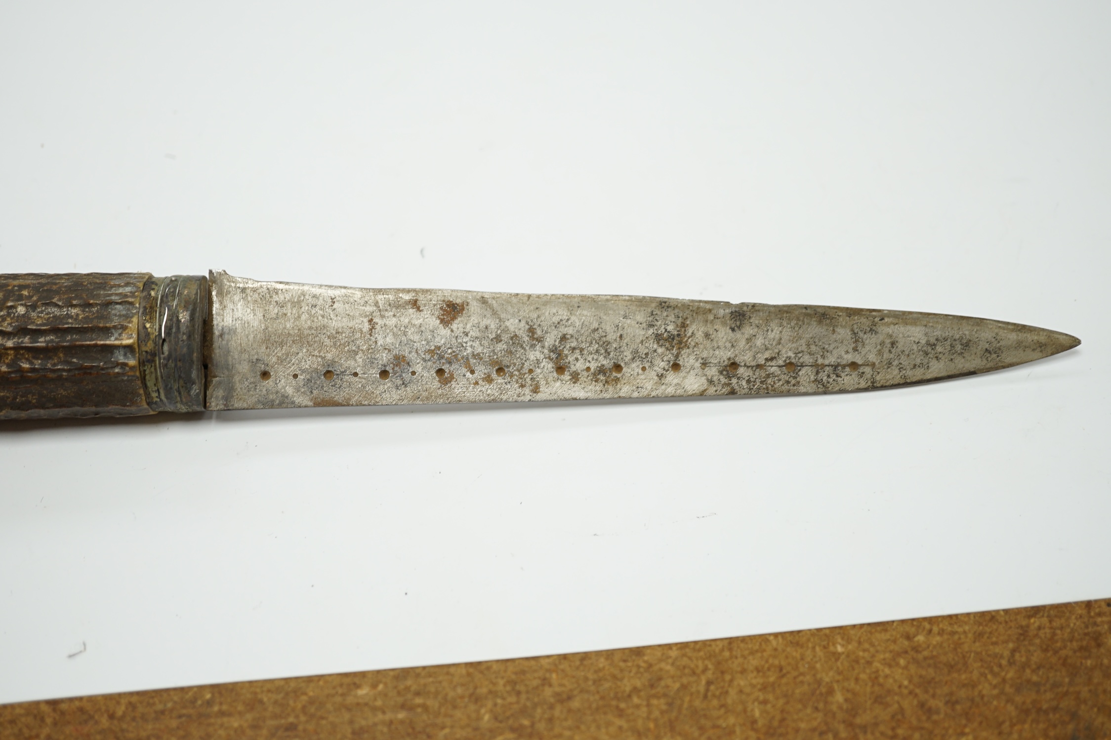 A Scottish dagger c.1900 with silvered mounts, including old initials engraved to pommel and applied to top mount, with deer skin covered sheath and antler grip, blade 19cm.